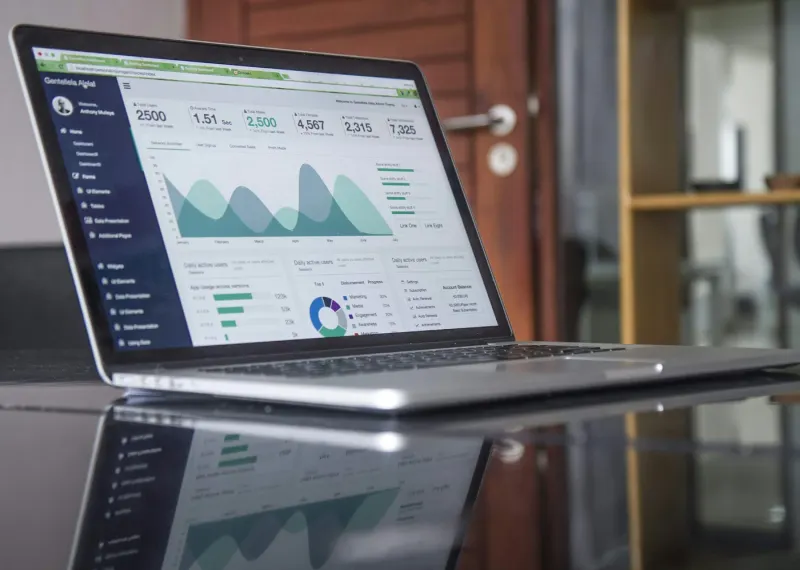 Laptop screen showing analytics charts and graphs